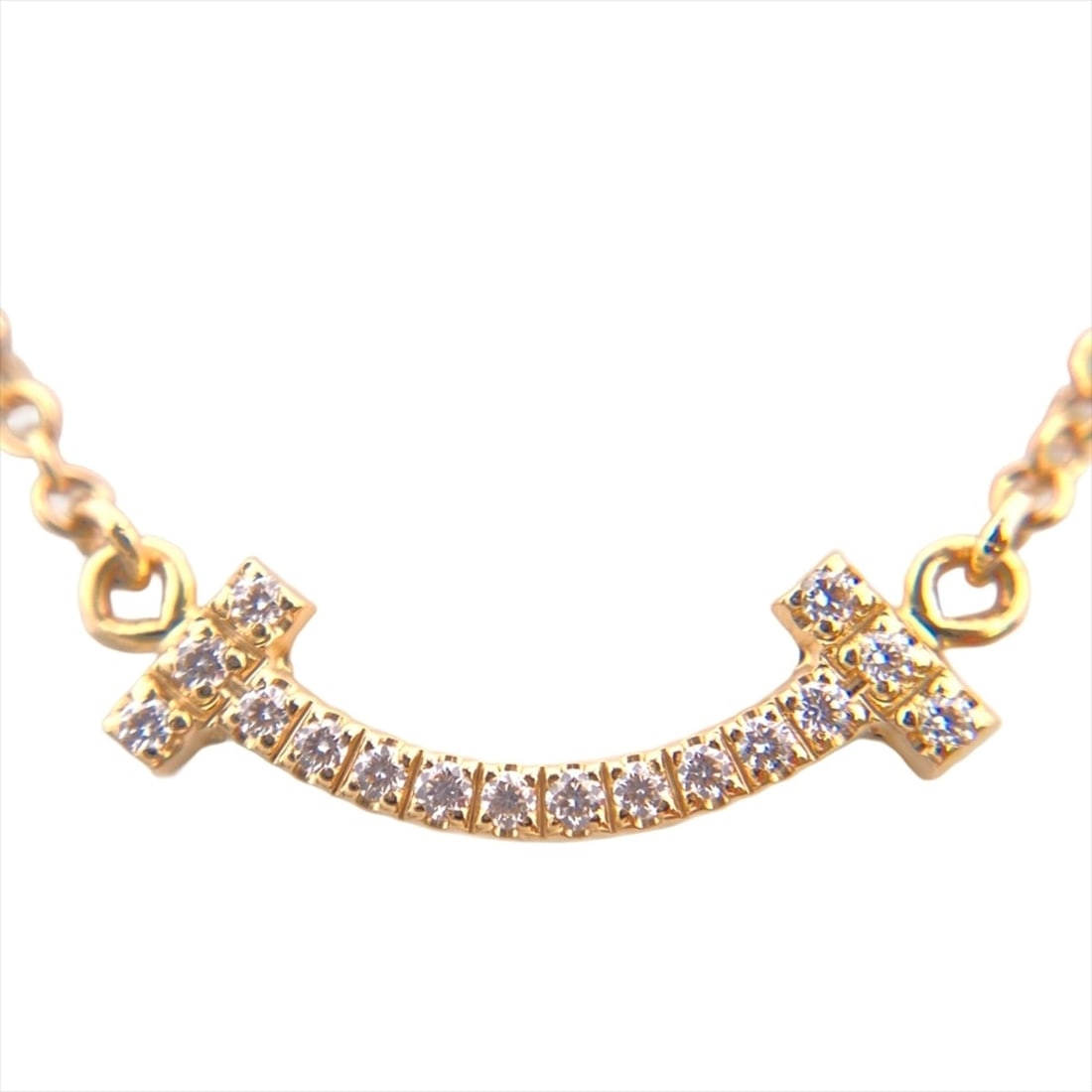 Tiffany & Co. T Smile Mini Necklace, 0.03ct Diamond, 18K Yellow Gold, 2.3g, Women's.: --- Catalog ---Category: SizePendant Size: 5mm x 13mm / 0.19'' x 0.51''Neck Circumference: 46 cm / 18.11''Category: DesignColor: Yellow goldGender: WomenMaterial: Yellow gold (18K)Necklace Type: Neckl