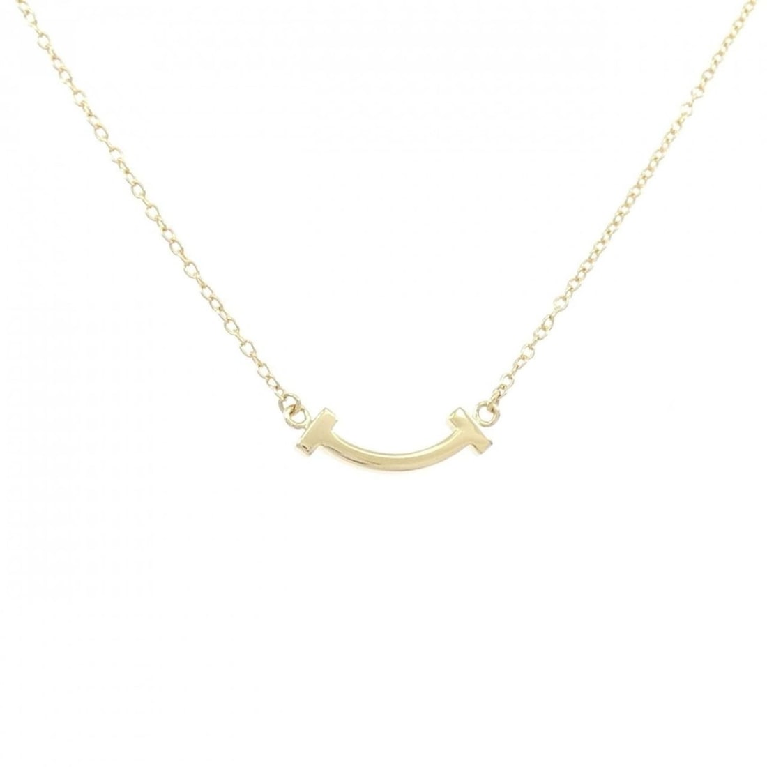 Tiffany T Smile Mini Necklace: --- Catalog ---Category: SizePendant Size: 3.4mm x 13.4mm / 0.13'' x 0.52''Neck Circumference: 46 cm - 52 cm / 18.11'' - 20.47''Category: DesignGender: WomenMaterial: Yellow gold (18K)Pendant Type: