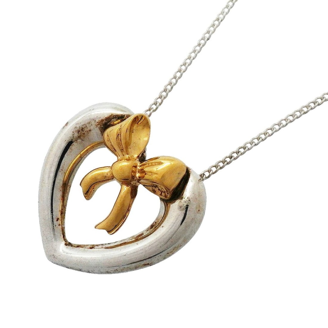 Tiffany & Co. Necklace, Heart Ribbon Design, 18K Yellow Gold (KYG), Sterling Silver (925), Women's: --- Catalog ---Category: SizePendant Size: 17.6mm x 18.1mm / 0.69'' x 0.71''Neck Circumference: 45.5 cm / 17.91''Category: DesignGender: WomenMaterial: Silver 925, Yellow gold (18K)Necklace Type: Neck