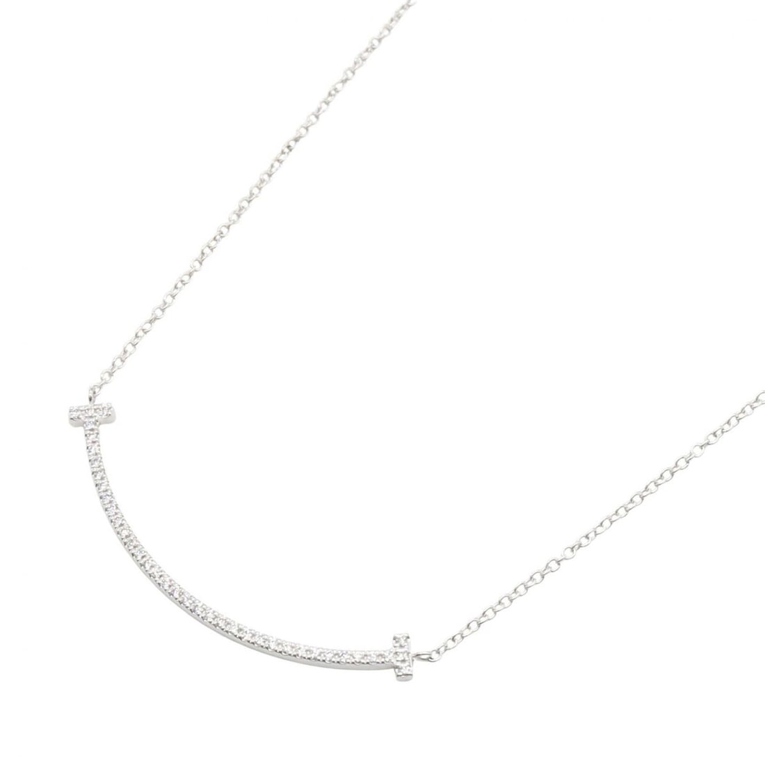 Tiffany & Co. T Smile Diamond Necklace, Small 18K White Gold (18KWG), Diamond, Women's, Silver/Clear: --- Catalog ---Category: SizePendant Size: 36mm x 3mm / 1.41'' x 0.11''Neck Circumference: 40.5 cm / 15.94''Category: DesignColor: Clear, WhiteGender: WomenMaterial: White gold (18K)Necklace Type: Nec