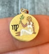 Art Deco Enamel Virgo Zodiac Charm in 14K Gold: Metal: 14K Yellow Gold Weight: 1.6 gramsMeasurements: 0.5 inch diameter Markings: "14K"Condition: In good condition with some minor surface wear consistent with ageFollow us on Instagram for the lates