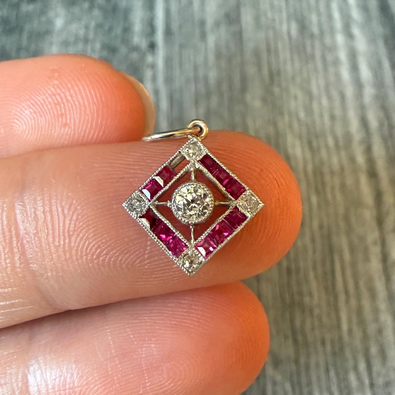Art Deco Diamond and Ruby Charm (H): Metal: 18K White Gold (acid tested)Weight: 1 gramDiamonds: Approximately 0.18 caratsRubies: Approximately 0.33 caratsMeasurements: 0.5 inches long by 0.5 inches wide Markings: NoneCondition: Most