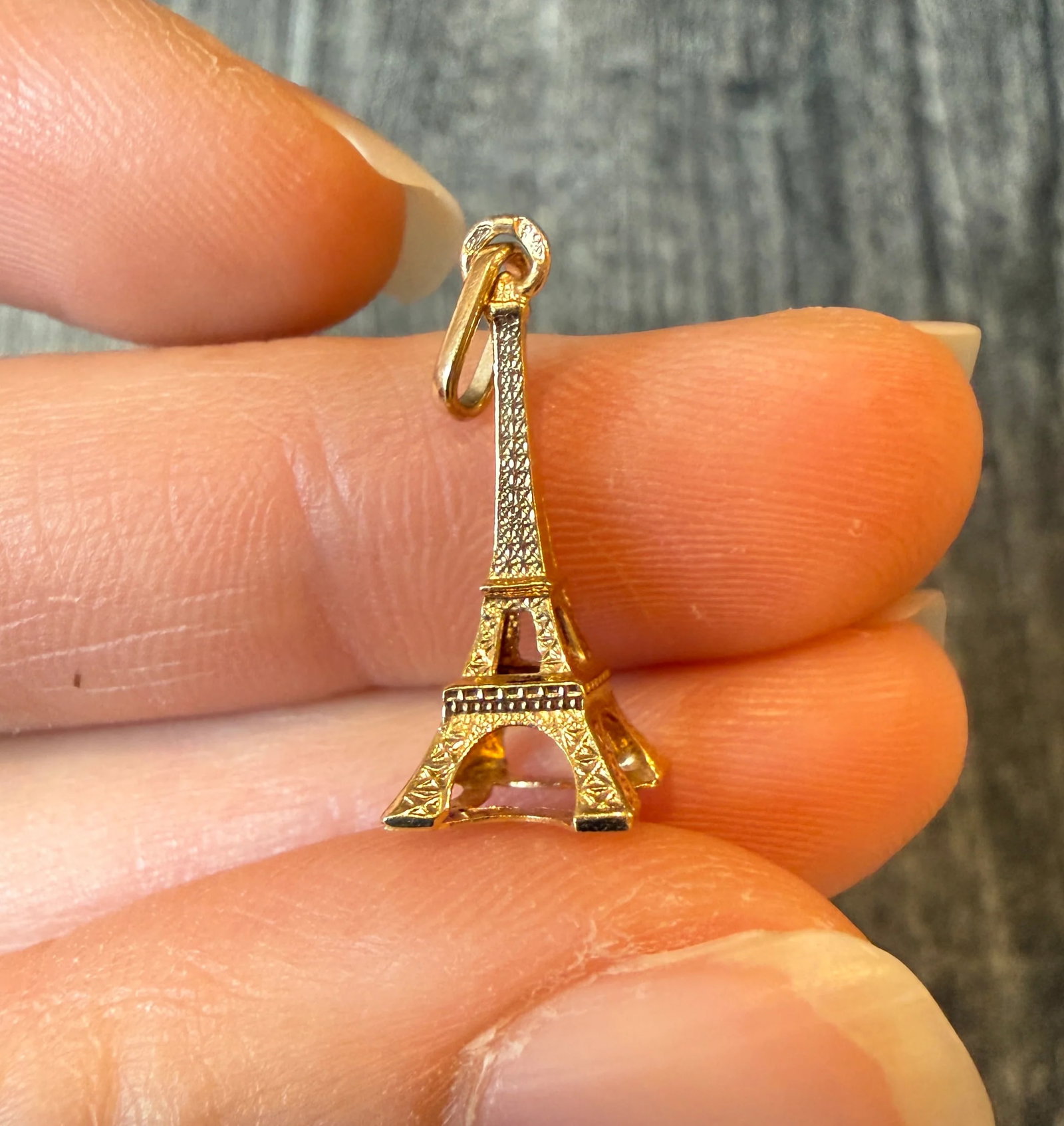French Eiffel Tower Charm in 18K Gold: Metal: 18K Yellow Gold Weight: 0.6 gramsMeasurements: 0.75 inches long by 0.3 inches wide Markings: French Hallmarks Condition: In very good condition with some minor surface wear Follow us on