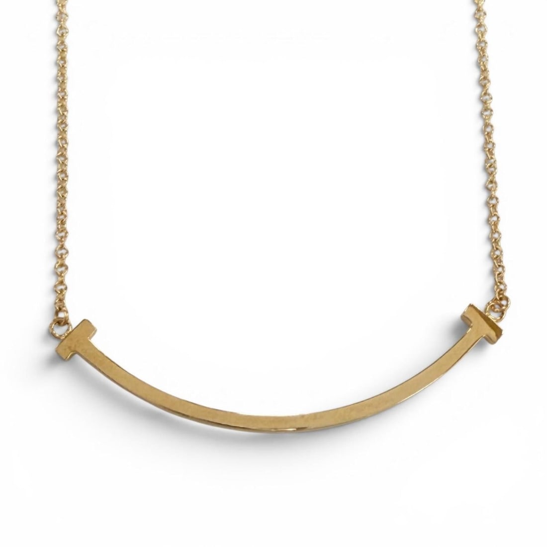 TIFFANY&Co. Tiffany T Smile Small AU750 (YG) Necklace, purchased March 2025, Yellow Gold, Weight: --- Catalog ---Category: SizePendant Size: 3mm x 36mm / 0.11'' x 1.41''Neck Circumference: 40.5 cm - 46 cm / 15.94'' - 18.11''Category: DesignColor: Yellow goldGender: WomenMaterial: Yellow gold (18K)