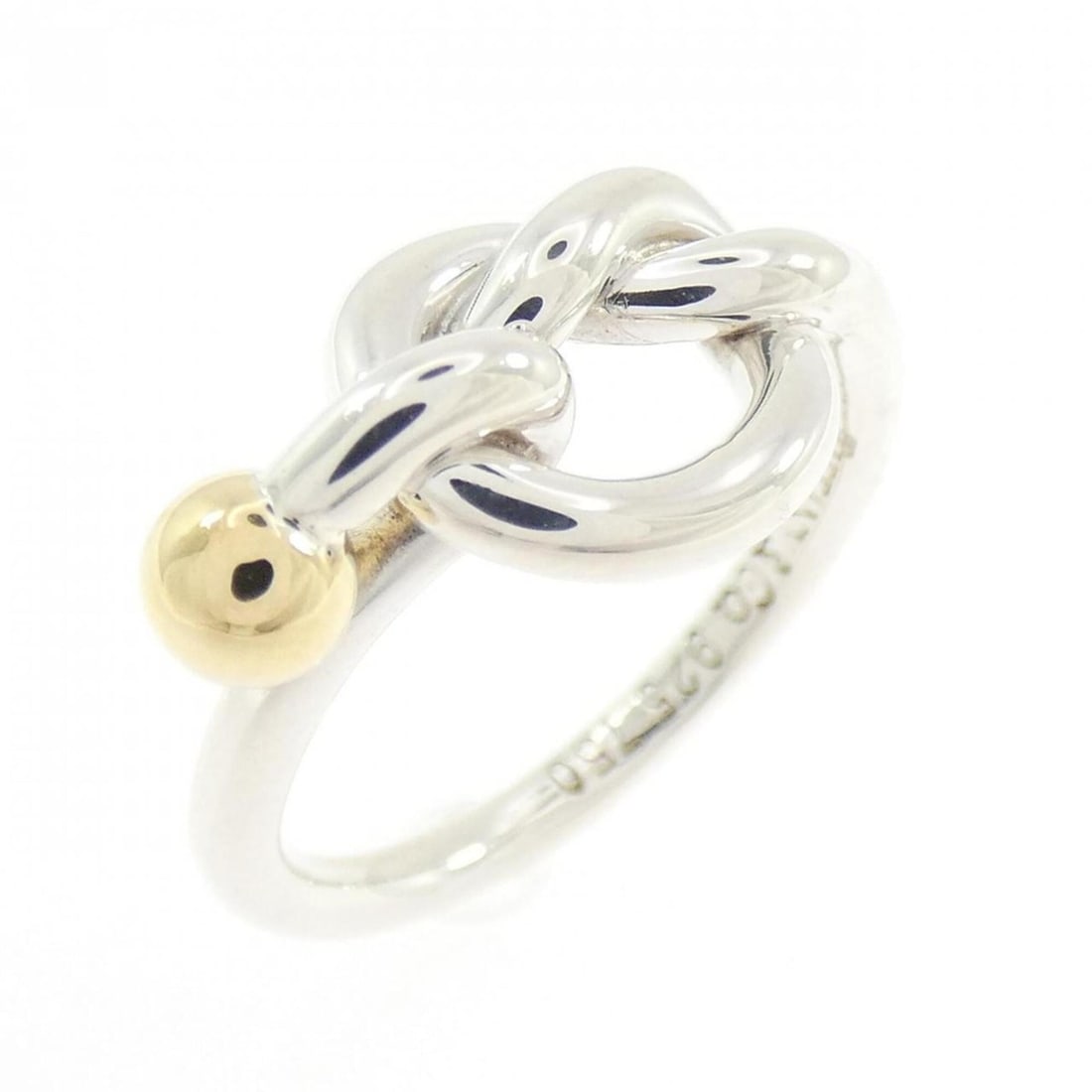 Tiffany Love Knot Ring: --- Catalog ---Category: SizeJP Size: 7.5US Size: 4Category: DesignType: Band ringGender: WomenMaterial: Silver 925, Yellow gold (18K)Category: GeneralBrand: Tiffany--- Item List ---Section:
