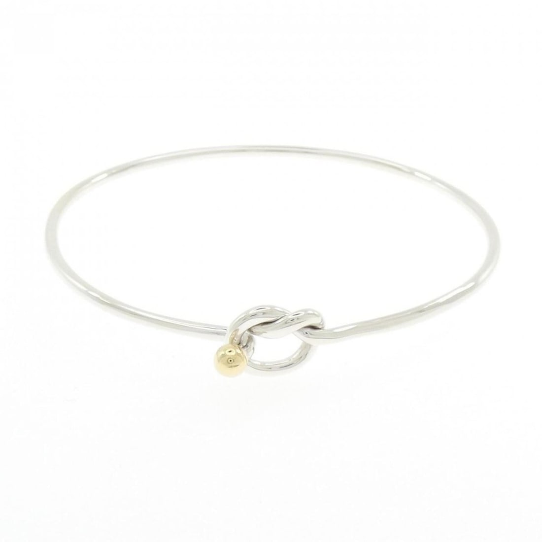 Tiffany & Co. Flat Wire Hook Eye Heart Bangle: --- Catalog ---Category: SizeLength: 17cm / 6.69''Category: DesignType: BangleGender: WomenMaterial: Silver 925, Yellow gold (18K)Category: GeneralBrand: Tiffany--- Item List ---Section: