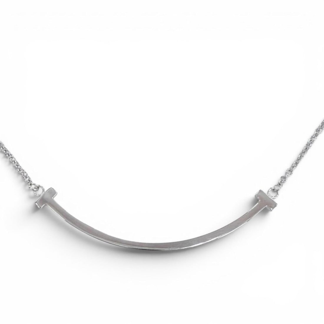 TIFFANY&Co. Tiffany T Smile Small AU750 (WG) Necklace, purchased November 2025, White Gold, Weight: --- Catalog ---Category: SizePendant Size: 4mm x 36mm / 0.15'' x 1.41''Neck Circumference: 40 cm - 45.5 cm / 15.74'' - 17.91''Category: DesignColor: White goldGender: WomenMaterial: White gold (18K)Ne