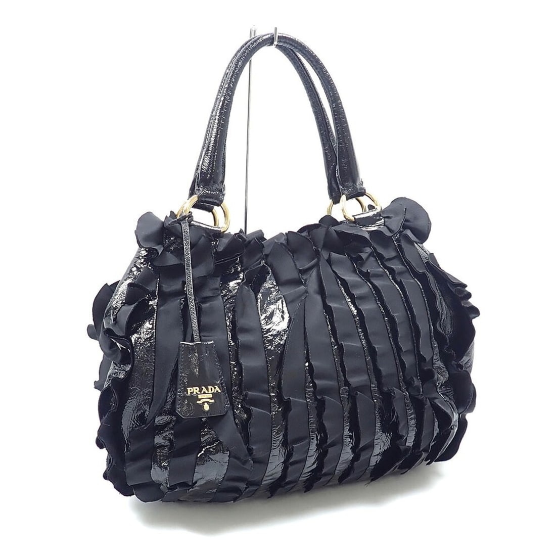 Prada Frill Handbag for Women, Black Nylon, BN1728: --- Catalog ---Category: SizeSize (HxWxD): 28cm x 40cm x 11cm / 11.02'' x 15.74'' x 4.33''Category: DesignType: HandbagColor: BlackGender: WomenMaterial: Nylon Category: GeneralBrand: Prada--- Item Li