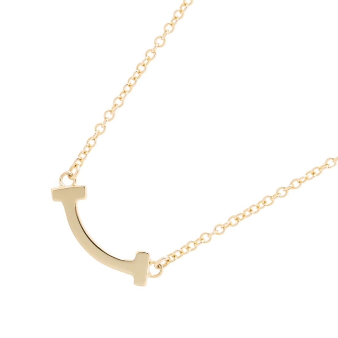 Tiffany & Co. T Smile Necklace, Mini Pendant, 18K Yellow Gold, 62617640.: --- Catalog ---Category: SizePendant Size: 3.6mm x 13.3mm / 0.14'' x 0.52''Neck Circumference: 41.5 cm - 46 cm / 16.33'' - 18.11''Category: DesignGender: WomenMaterial: Yellow gold (18K)Pendant Type: 
