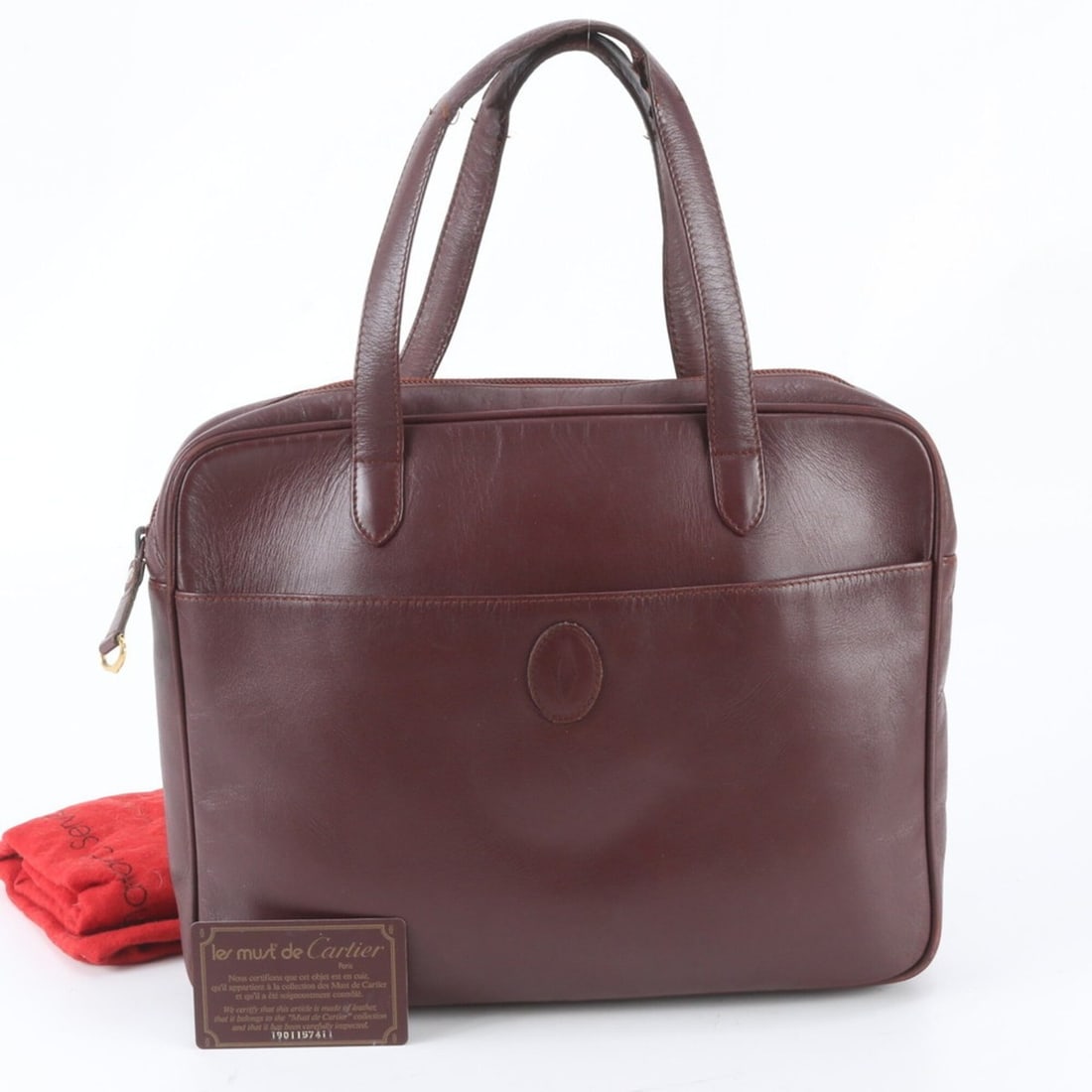 Cartier Must Line Leather Handbag/Tote Bag for Women (with Guarantee Card): --- Catalog ---Category: SizeSize (HxWxD): 25cm x 31cm x 5cm / 9.84'' x 12.2'' x 1.96''Handle Length: 40cm / 15.74''Category: DesignType: Handbag, Tote bagColor: Wine redGender: WomenMaterial: Leather