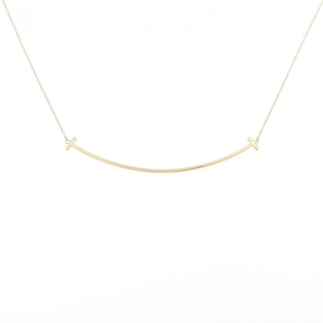 Tiffany & Co. T Smile Large Necklace: --- Catalog ---Category: SizePendant Size: 5.9mm x 68.4mm / 0.23'' x 2.69''Neck Circumference: 40 cm - 46 cm / 15.74'' - 18.11''Category: DesignGender: WomenMaterial: Yellow gold (18K)Pendant Type: