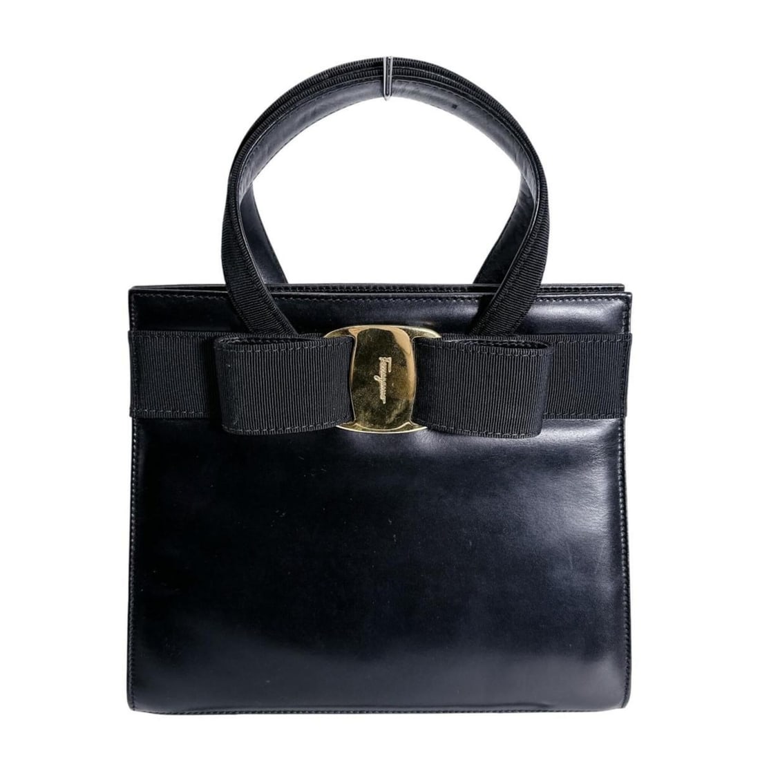 Salvatore Ferragamo Compact Handbag, Vara Ribbon, Leather, Black: --- Catalog ---Category: SizeWeight: 541g / 1.19lb.Handle Drop: 7.50cm / 2.95''Size (HxWxD): 21cm x 24.5cm x 10cm / 8.26'' x 9.64'' x 3.93''Category: DesignType: HandbagColor: BlackGender: WomenClosur