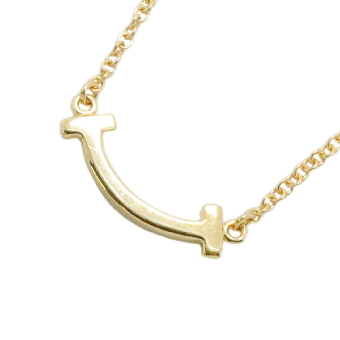 Tiffany & Co. T Smile Mini Necklace, 18K Yellow Gold, Women's: --- Catalog ---Category: SizePendant Size: 4.5mm x 14.1mm / 0.17'' x 0.55''Neck Circumference: 40.5 cm - 46 cm / 15.94'' - 18.11''Category: DesignGender: WomenMaterial: Yellow gold (18K)Necklace Type: