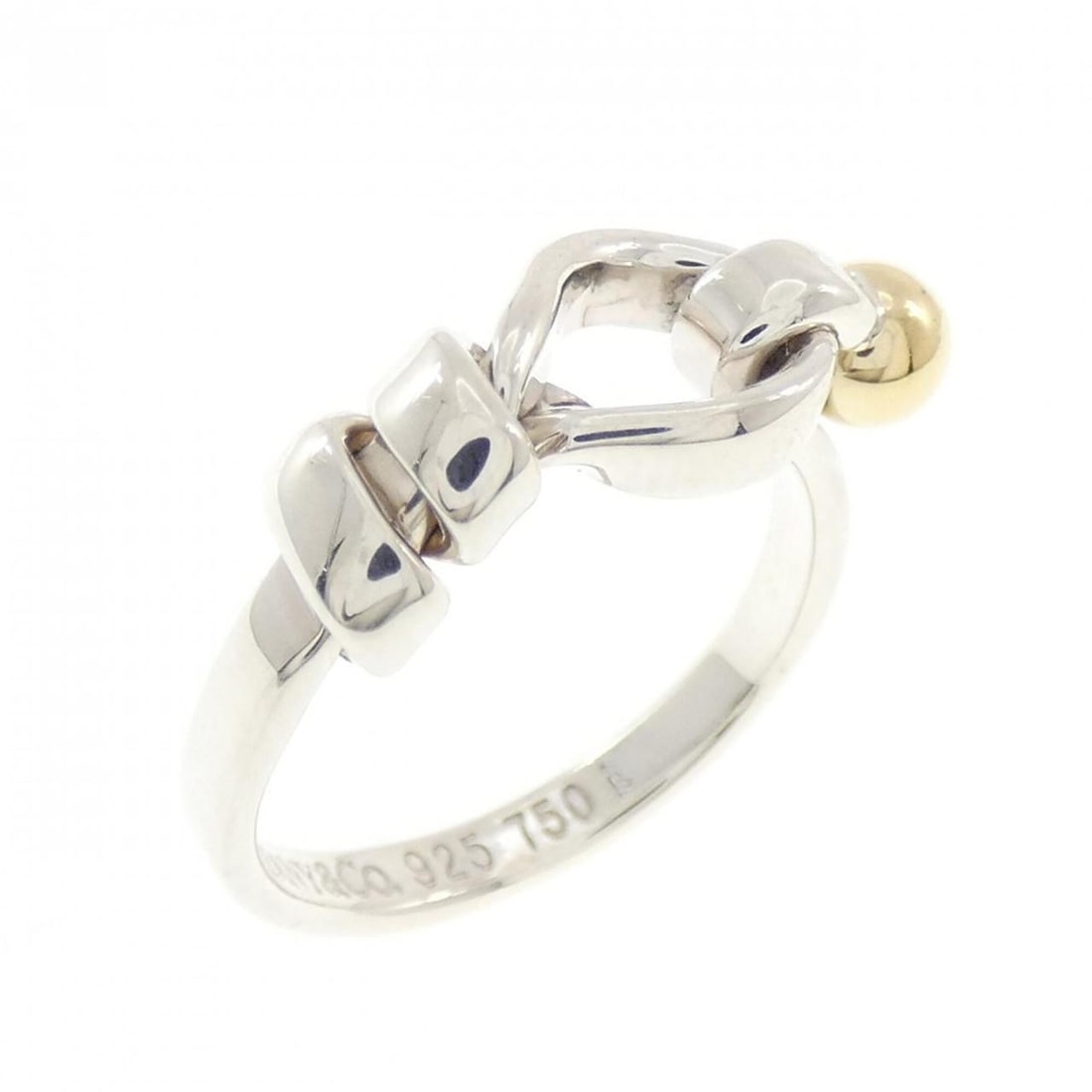 Tiffany & Co. Flat Wire Love Knot Ring: --- Catalog ---Category: SizeJP Size: 7US Size: 4Category: DesignType: Band ringColor: Silver, Yellow goldGender: WomenMaterial: Silver 925, Yellow gold (18K)Category: GeneralBrand: Tiffany--- Item