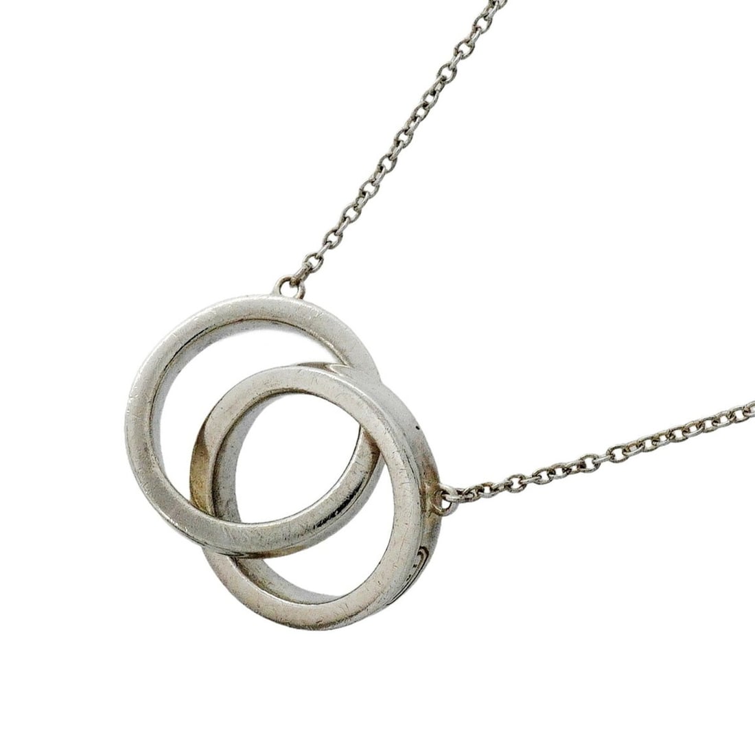 Tiffany & Co. 1837 Interlocking Sterling Silver Necklace for Women: --- Catalog ---Category: SizePendant Size: 14mm x 24.6mm / 0.55'' x 0.96''Neck Circumference: 41 cm / 16.14''Category: DesignGender: WomenMaterial: Silver 925Necklace Type: NecklaceCategory: GeneralBr