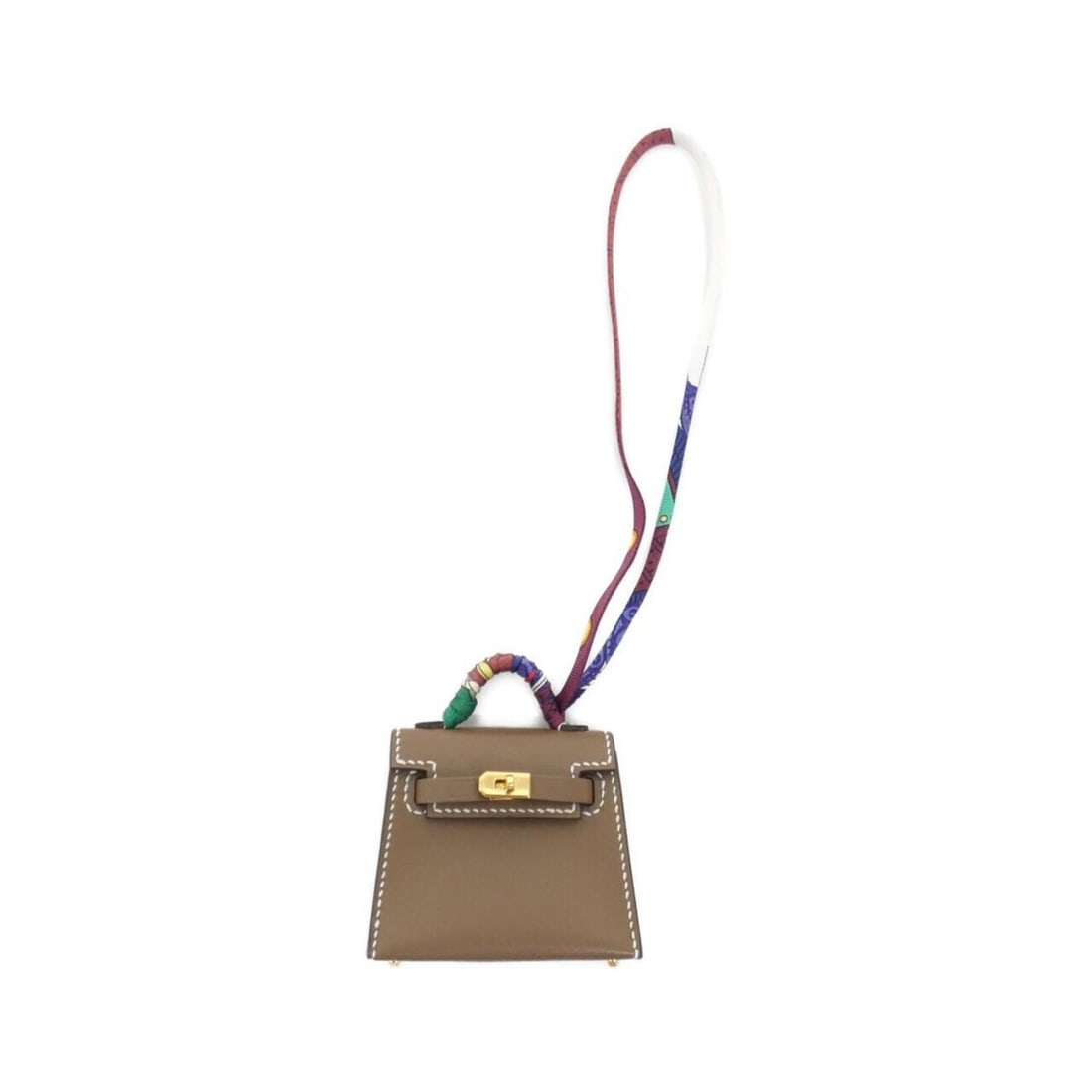 Hermes Kelly Twilly Mini Accessory Bag Charm: --- Catalog ---Category: SizeSize (HxWxD): 55.00mm x 65.00mm x 25.00mm / 2.17'' x 2.56'' x 0.98''Category: DesignType: Handbag charmColor: Etoupe gray, GoldGender: WomenMaterial: Silk, Tadelakt leathe