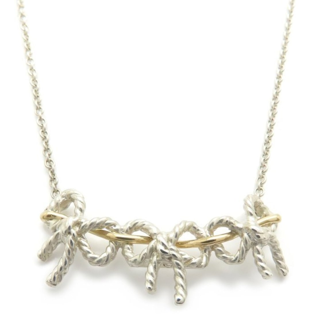 TIFFANY&Co. Triple Ribbon Necklace, Sterling Silver 925 x 18K Yellow Gold, Women's, Item Number: --- Catalog ---Category: SizePendant Size: 13.9mm x 33.5mm / 0.54'' x 1.31''Neck Circumference: 44 cm / 17.32''Category: DesignColor: Silver, Yellow goldGender: WomenMaterial: Silver 925, Yellow gold 