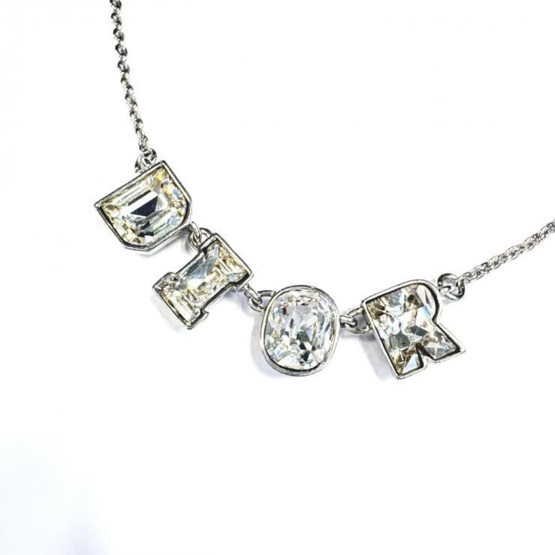Dior Bijou Logo Necklace, Silver, Clear: --- Catalog ---Category: SizePendant Size: 9mm x 38mm / 0.35'' x 1.49''Neck Circumference: 37 cm - 43.5 cm / 14.56'' - 17.12''Category: DesignColor: Clear, SilverGender: WomenMaterial: Metal, Rhinesto