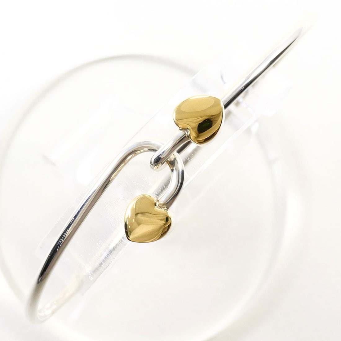 Tiffany & Co. Love Knot 18K Yellow Gold Silver Bangle, Total Weight 12.4g, Jewelry: --- Catalog ---Category: SizeLength: 17cm / 6.69''Weight: 12.4g / 0.43oz.Category: DesignType: BangleGender: WomenMaterial: Silver 925, Yellow gold (18K)Category: GeneralBrand: Tiffany--- Item List --
