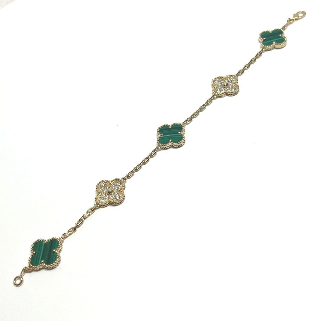 Van Cleef & Arpels 18K Yellow Gold Vintage Alhambra Malachite Diamond Bracelet - Women's Jewelry: --- Catalog ---Category: SizeLength: 18cm / 7.08''Category: DesignType: Charm braceletColor: Gold, GreenStone: Diamond, MalachiteGender: WomenMaterial: Gold (18K)Category: GeneralBrand: Van Cleef & Ar