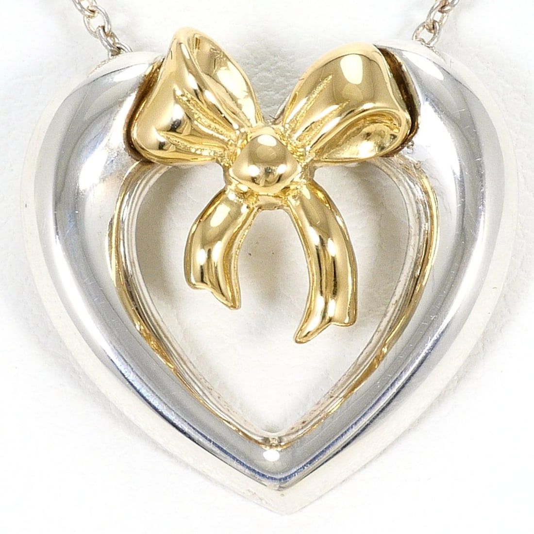 Tiffany & Co. Heart Ribbon 18K Yellow Gold Silver Necklace, Total Weight 4.6g, 41cm, Jewelry: --- Catalog ---Category: SizeWeight: 4.6g / 0.16oz.Pendant Size: 17mm x 18mm / 0.66'' x 0.7''Neck Circumference: 41 cm / 16.14''Category: DesignGender: WomenMaterial: Silver 925, Yellow gold (18K)Neck