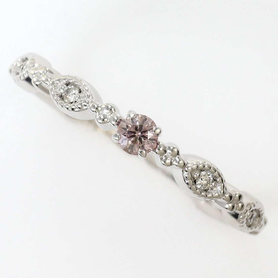 18K (18-karat white gold) ring, 1 pink diamond (0.07ct), 0.03ct diamond, total weight 1.9g, jewelry.: --- Catalog ---Category: SizeWidth: 3mm / 0.12''Weight: 1.9g / 0.06oz.JP Size: 12US Size: 6.5Category: DesignType: Band ringColor: Pink, White goldMetal: White GoldStone: DiamondMaterial: White gold (