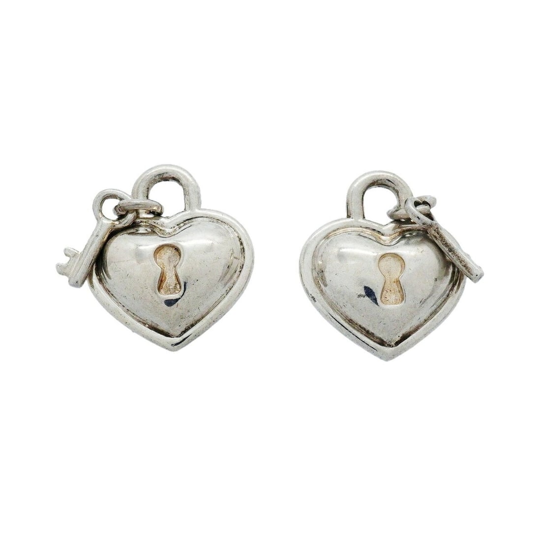 Tiffany & Co. Heart Lock Key Earrings, Sterling Silver 925, Women's: --- Catalog ---Category: SizeSize (HxWxD): 17.40mm x 15.00mm / 0.69'' x 0.59''Category: DesignType: Stud earringsGender: WomenMaterial: Silver 925Category: GeneralBrand: Tiffany--- Item List ---Sectio