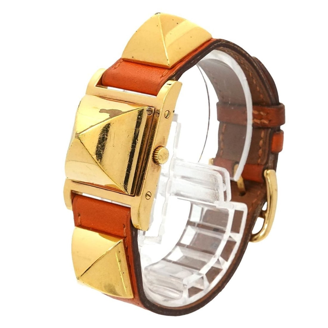 Hermes Medor Women's Watch, Pyramid Design, Gold Studs, White and Orange Leather Strap, Quartz: --- Catalog ---Category: SizeWrist Size: 14cm - 16.5cm / 5.51'' - 6.49''Case Diameter: 23mm / 0.91''Category: DesignType: WristwatchGender: WomenColor (Dial): WhiteMaterial (Band): Gold plated, Leathe