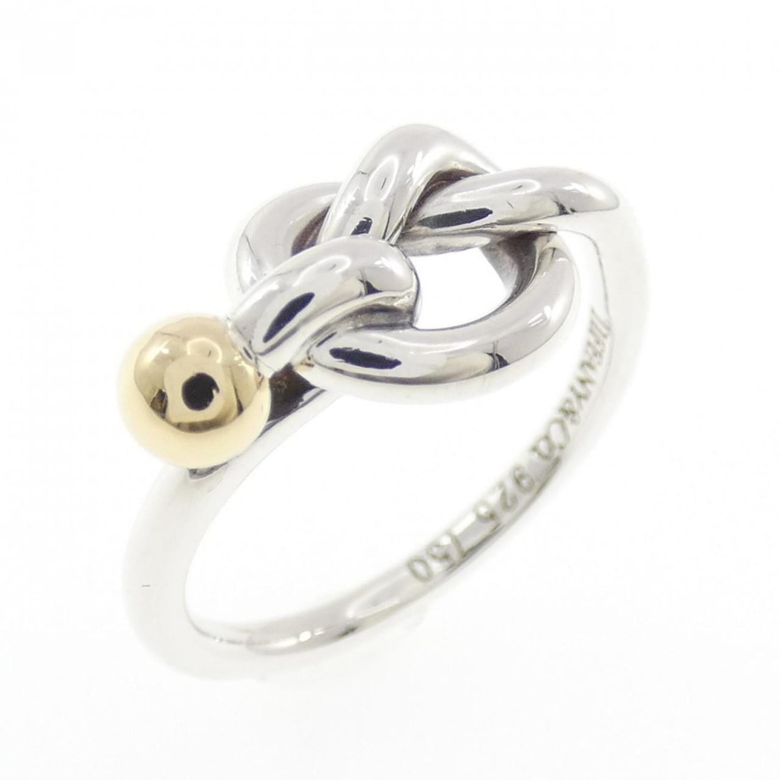 Tiffany Love Knot Ring: --- Catalog ---Category: SizeJP Size: 8.0US Size: 4.5Category: DesignType: Band ringGender: WomenMaterial: Silver 925, Yellow gold (18K)Category: GeneralBrand: Tiffany--- Item List ---Section: