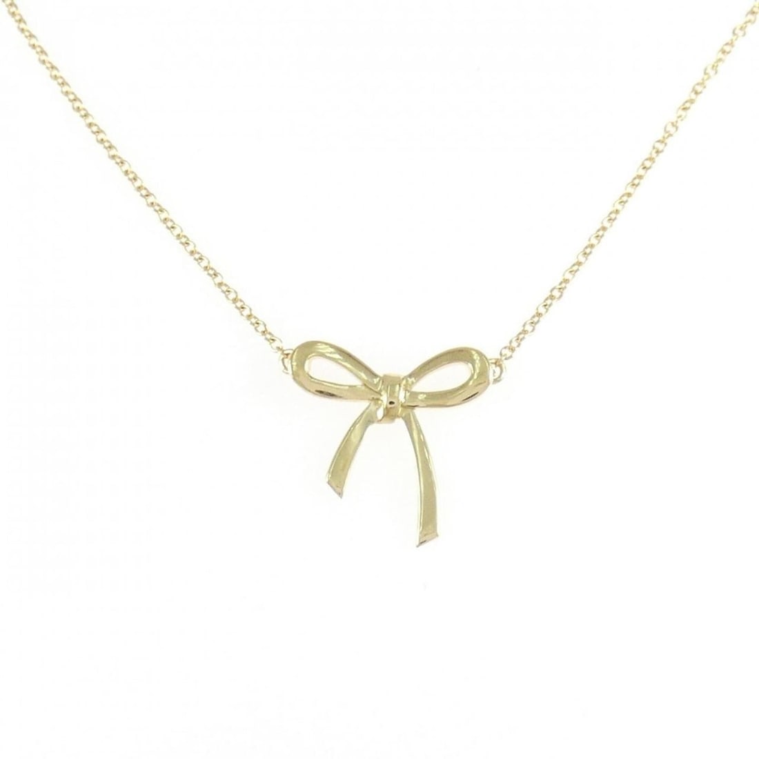 Tiffany Bow Mini Necklace: --- Catalog ---Category: SizePendant Size: 14.7mm x 15mm / 0.57'' x 0.59''Neck Circumference: 41 cm / 16.14''Category: DesignGender: WomenMaterial: Yellow gold (18K)Pendant Type: PendantNecklace Type: