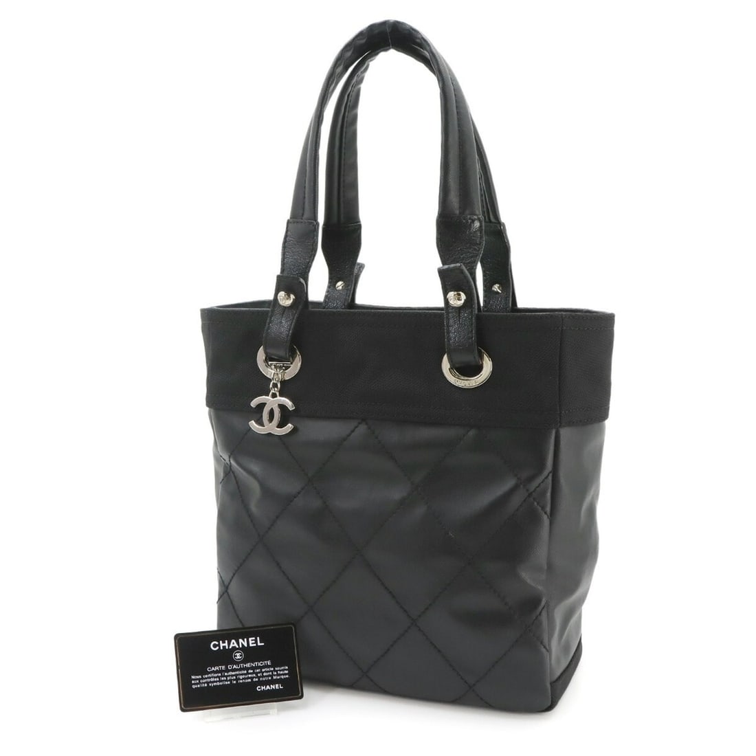Chanel Paris Biarritz PM Tote Handbag, Nylon and Leather, Black, A34208, Silver Hardware: --- Catalog ---Category: SizeSize (HxWxD): 26.5cm x 25.5cm x 11cm / 10.43'' x 10.03'' x 4.33''Category: DesignType: Handbag, Tote bagColor: BlackGender: WomenMaterial: Nylon , Leather Category: Genera