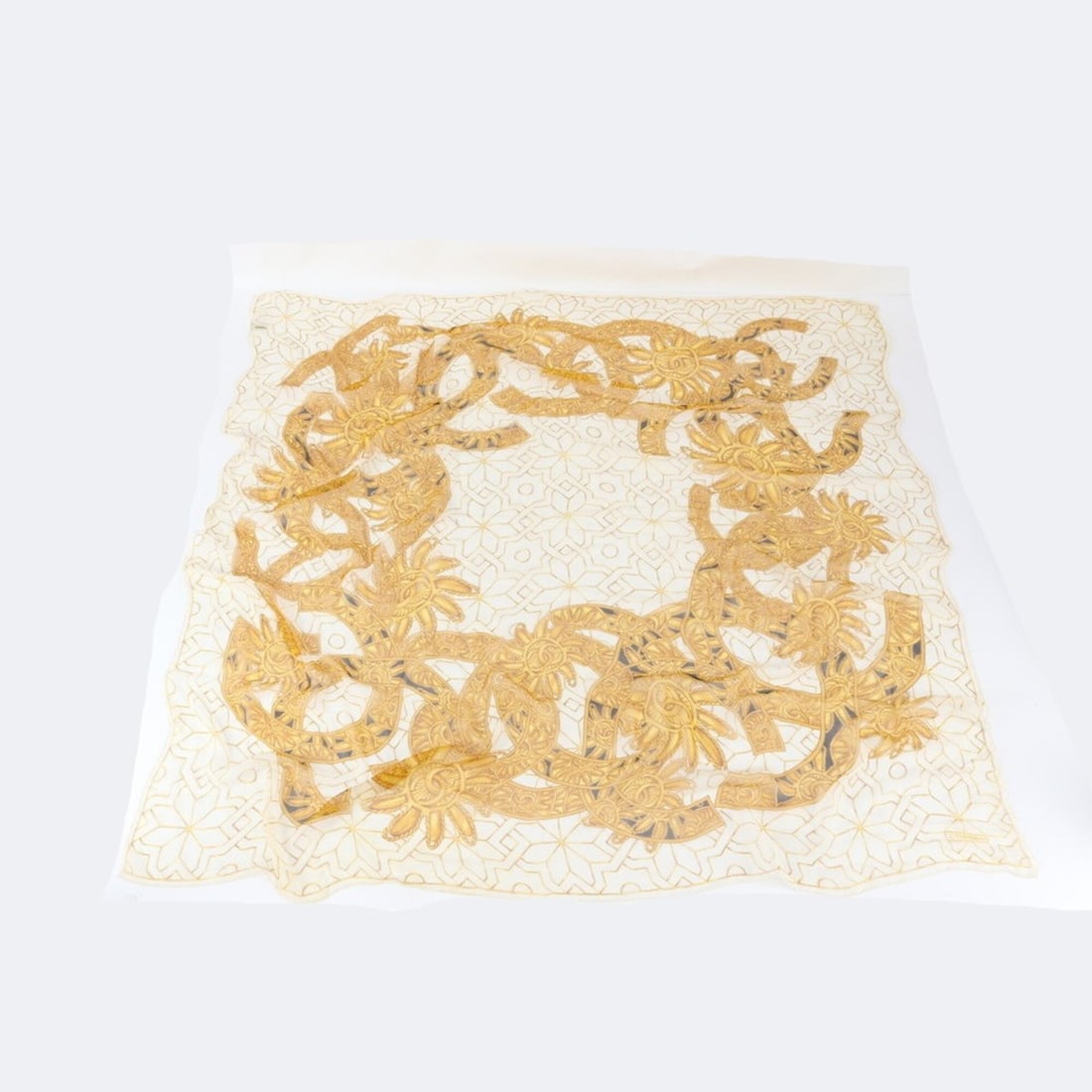 Chanel tagged 100% silk scarf with Coco Mark accessory pattern for women and men.: --- Catalog ---Category: SizeSize (LxW): 1.2m x 1.28m / 47.24'' x 50.39''Category: DesignType: ScarfColor: Beige, GoldGender: Men,WomenMaterial: Silk Category: GeneralBrand: ChanelCountry of Origin: I
