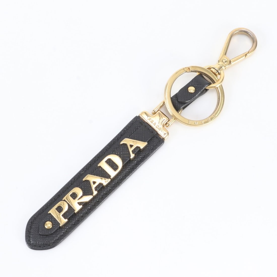 Prada Saffiano Keyring Bag Charm Leather Keychain for Women: --- Catalog ---Category: SizeSize (HxWxD): 15cm x 2cm x 1cm / 5.9'' x 0.78'' x 0.39''Category: DesignType: KeyringColor: Black, GoldGender: WomenMaterial: LeatherCategory: GeneralBrand: Prada--- Item 