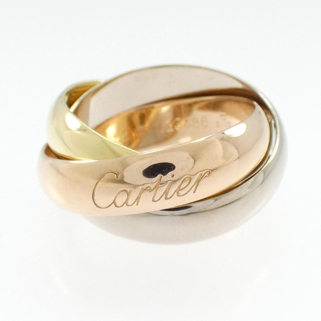 Cartier Trinity Large Ring: --- Catalog ---Category: SizeUS Size: 6.5Brand Size: 52Category: DesignType: Band ringGender: WomenMaterial: Pink gold (18K), White gold (18K), Yellow gold (18K)Category: GeneralBrand: Cartier--- Item