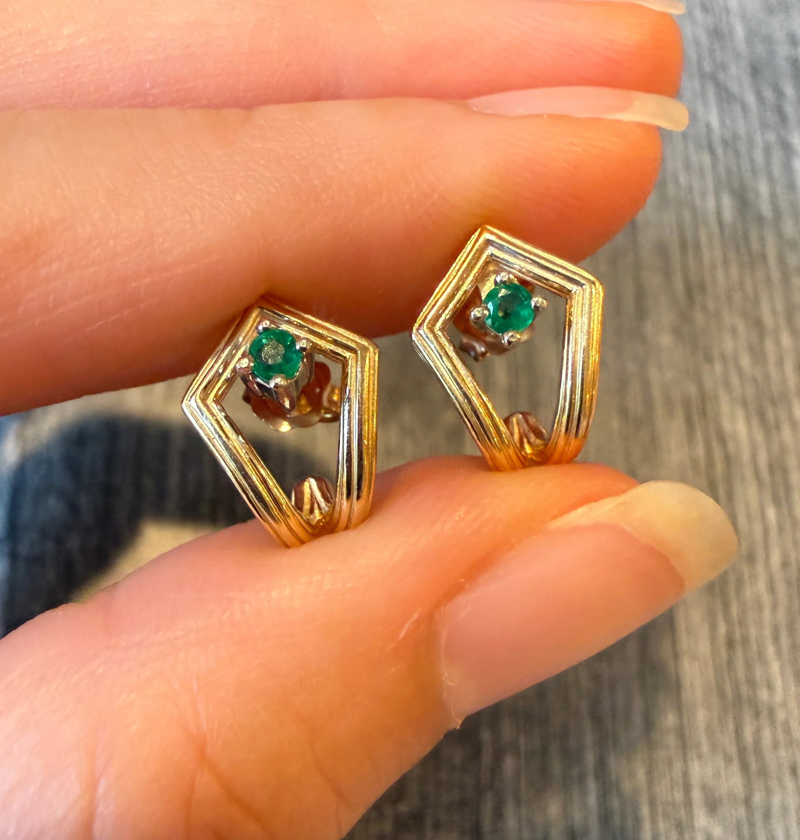 Emerald and 14K Gold Open Kite Shaped Huggie Earrings: Metal: 14K Yellow Gold Weight: 2.9 gramsEmeralds: Approximately 0.20 caratsMeasurements: 0.55 inches long by 0.45 inches wideMarkings: "14K"Condition: In very good condition with some minor surface
