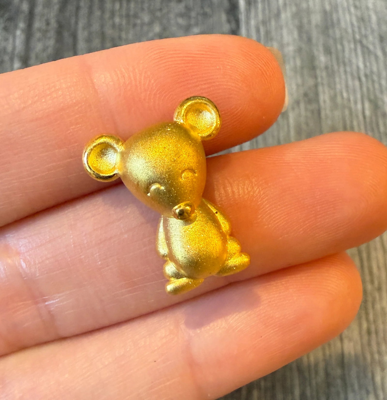 Cartoon Mouse Slide Charm in 24K Gold (I): Metal: 24K Yellow Gold Weight: 1.8 gramsMeasurements: 0.8 inches long by 0.65 inches wide Markings: "9999"Condition: In very good condition with some minor surface wear.