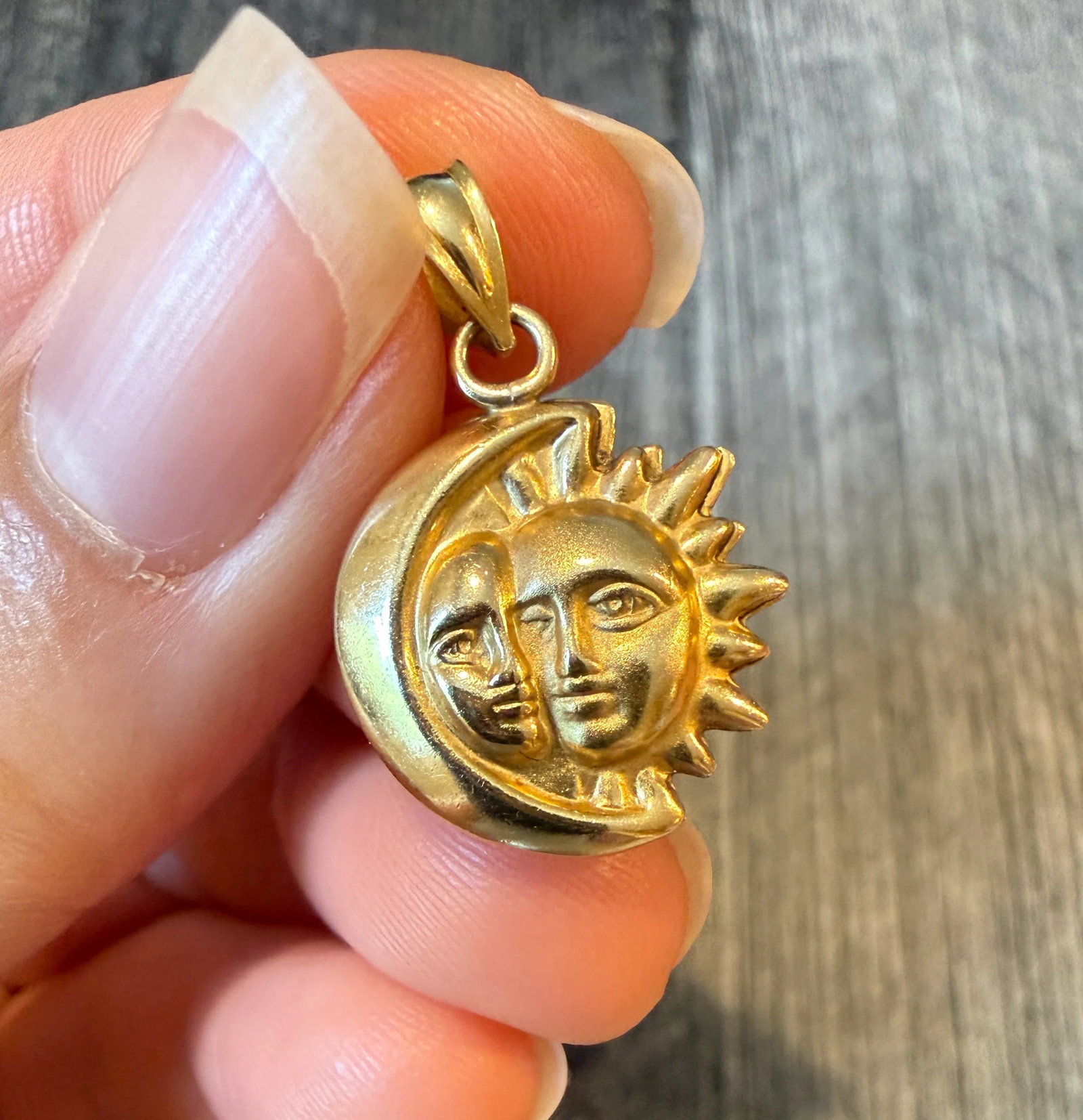 Puffy Celestial Sun and Moon Charm in 14K Gold: Metal: 14K Yellow Gold Weight: 1.8 gramsMeasurements: 0.65 inches diameterMarkings: "14K"Condition: In very good condition with some minor surface wear.