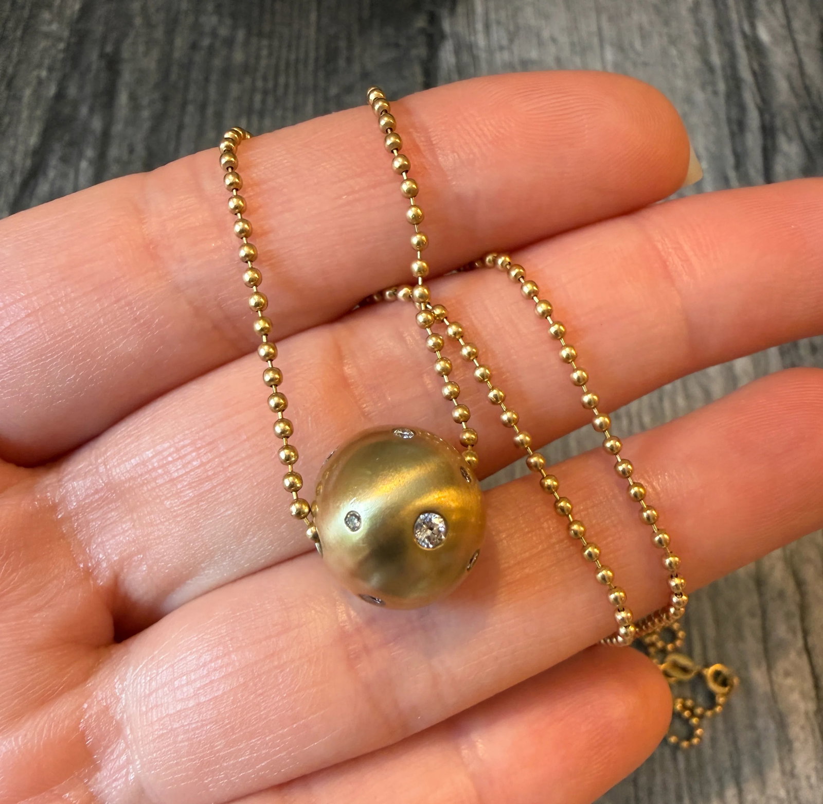 Diamond Etoile Gold Slide and 18K Gold Ball Necklace: Metal: 18K Yellow GoldWeight: 12.6 gramsBall Slide Charm: 13.8 mm diameter Chain: 19.5 inches long by 1.5 mm wideDiamonds: Approximately 0.45 caratsMarkings: "750"Condition: In very good condition wit