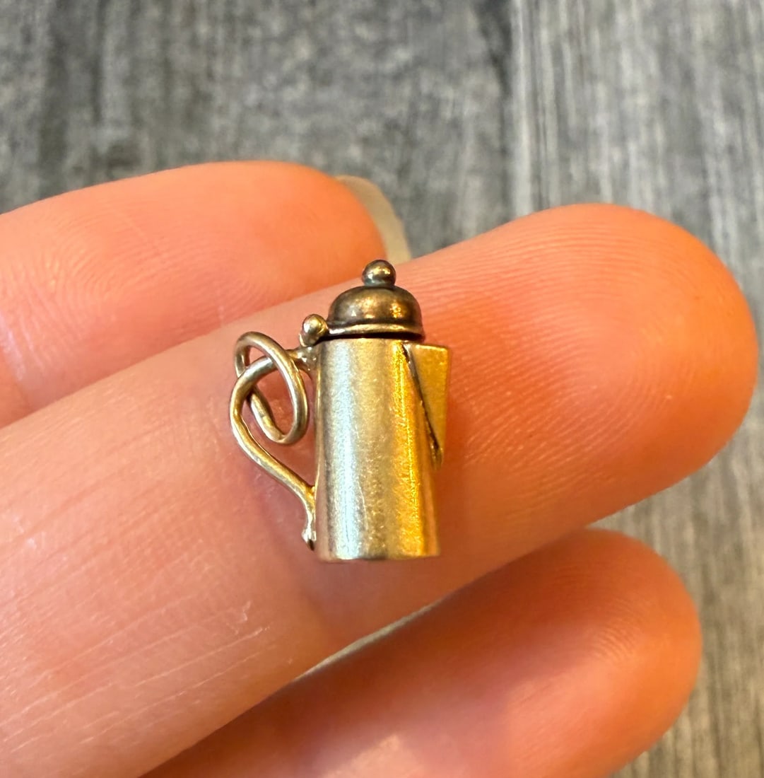 Movable 14K Gold Teapot Charm: Metal: 14K Yellow Gold Weight: 1 gramMeasurements: 0.5 inches long by 0.4 inches wideMarkings: "14K"Condition: In good condition with some minor surface wear.