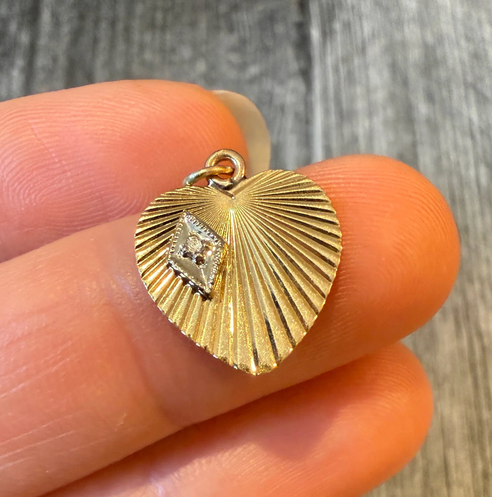 Mini Engine Turned Heart Charm with Diamond Accent 1/2: Metal: 14K Yellow Gold (acid tested)Weight: 1.2 gramsMeasurements: 0.55 inches long by 0.5 inches wide Diamond: Approximately 0.01 caratCondition: In good condition with some minor surface wear.