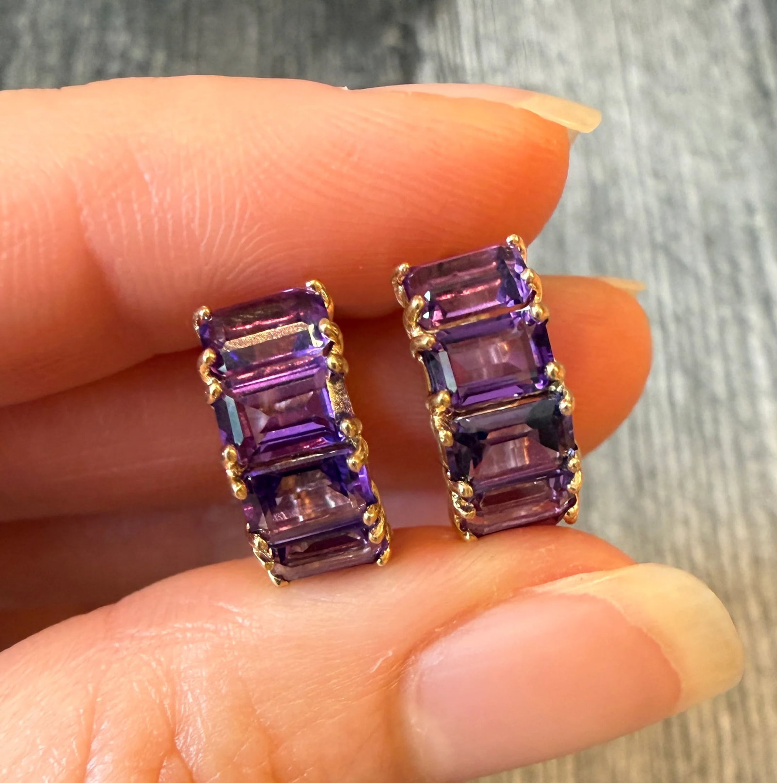 Step Cut Amethyst Huggie Earrings in 14K Gold (I): Metal: 14K Yellow Gold Weight: 5 gramsAmethyst: Approximately 5.5 caratsMeasurements: 0.55 inches long Markings: "14K"Condition: In very good condition with some minor surface wear.