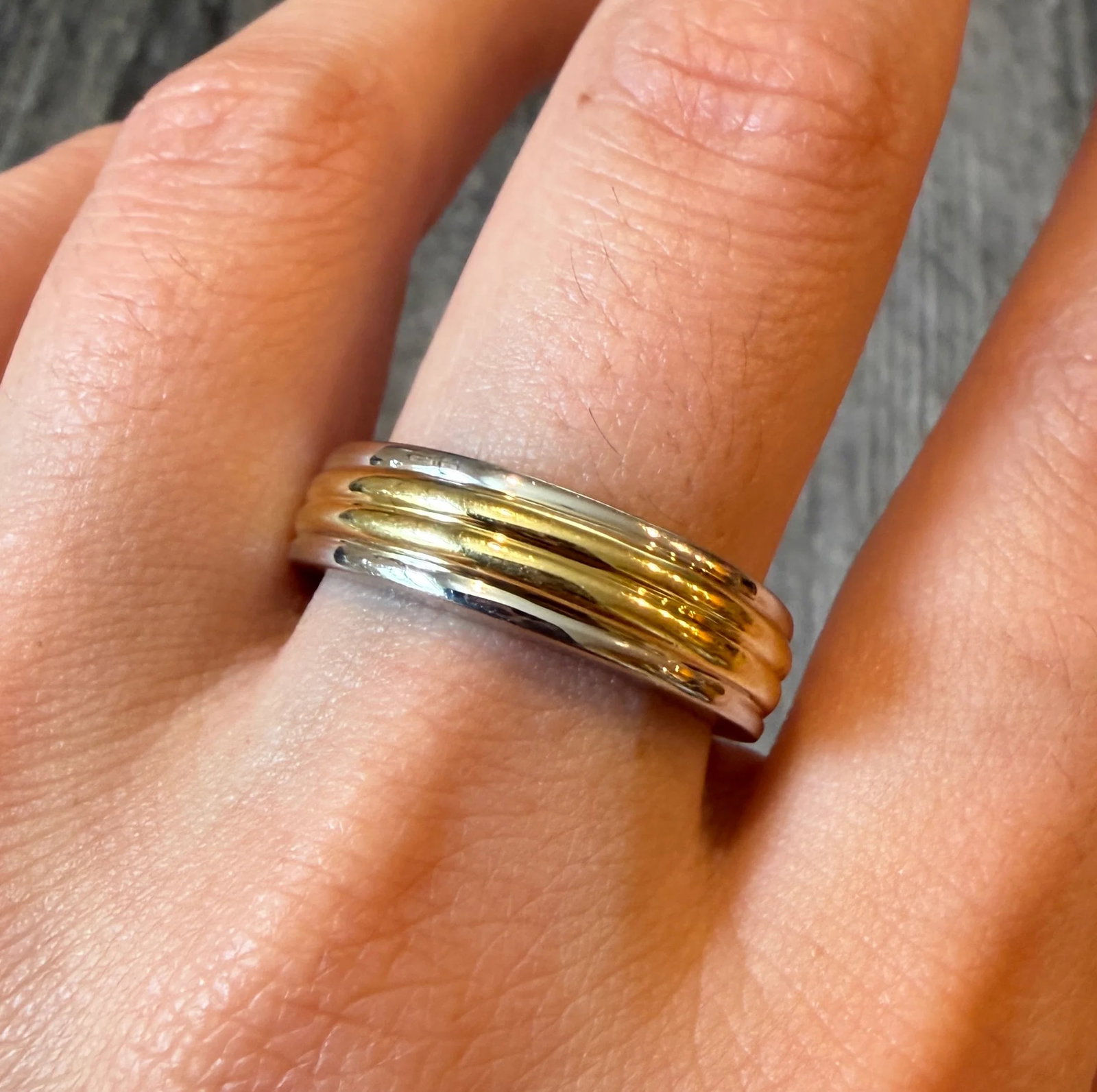 Ribbed Platinum and 18K Gold Band, Size 10.5 (I): Metal: Platinum and 18K Yellow Gold Weight: 14.7 gramsRing Size: 10.5 (resizable)Width: 6.5 mm wideMarkings: "PLAT 750"Condition: In very good condition with some minor surface wear.