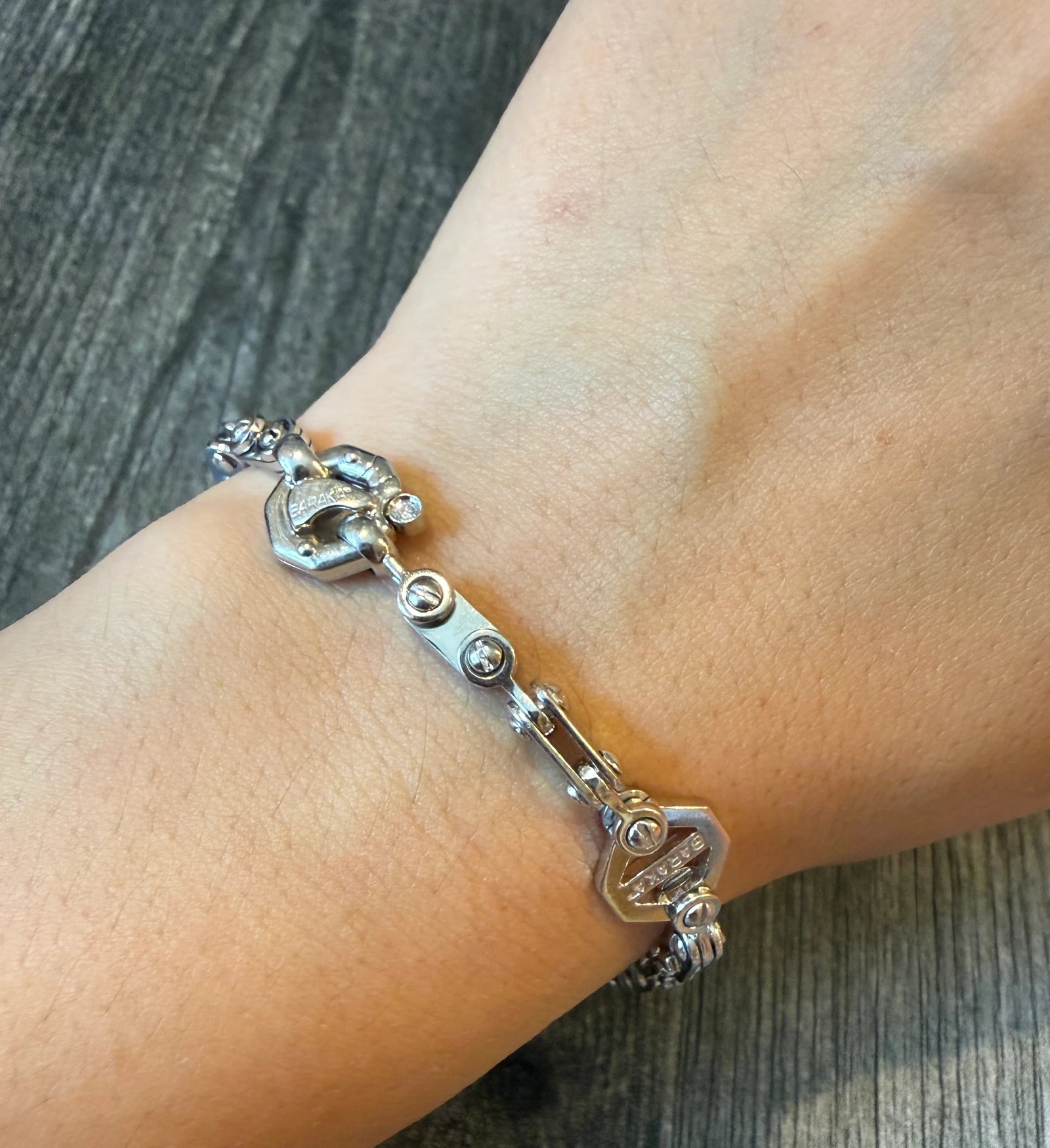 Baraka Jointed Bike Chain Bracelet in 18K White Gold (I): Metal: 18K White Gold Weight: 27.7 gramsMeasurements: 8.6 inches long by 10.9 mm wide Markings: "BARAKA 750"Condition: In very good condition with some minor surface wear.