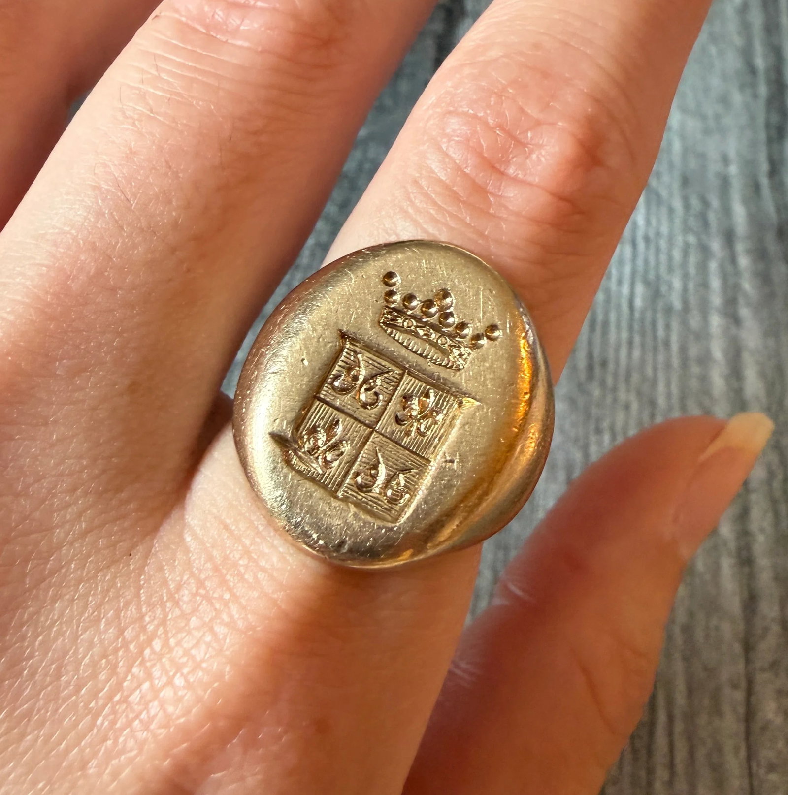 Solid Hand-Engraved Shield Signet Ring in 14K Gold with Fleur de Lis and Crown Motif: Metal: 14K Yellow Gold Weight: 21.4 gramsRing Size: 8 (fits slightly smaller due to width and is resizable)Markings: "14K"Condition: In good condition with some surface wear and one deep scratch to th