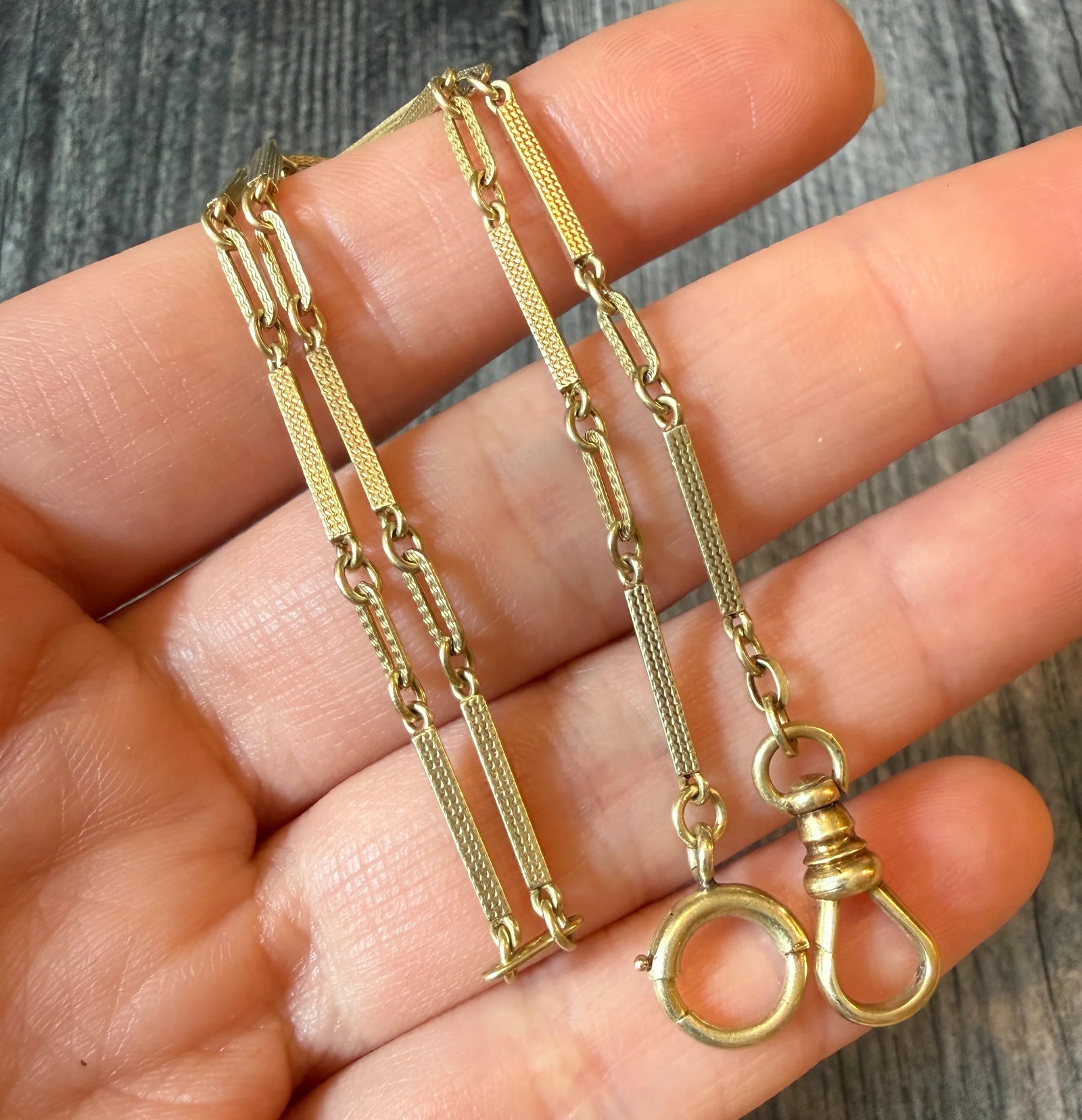 Art Deco 14K Gold Chased Bar Link Watch Chain, 13?? Long: Metal: 14K Yellow Gold Weight: 9.9 gramsMeasurements: 13 inches long by 1.5 mm wideMarkings: "Automatic 14K" Condition: In very good antique condition with some minor surface wear.