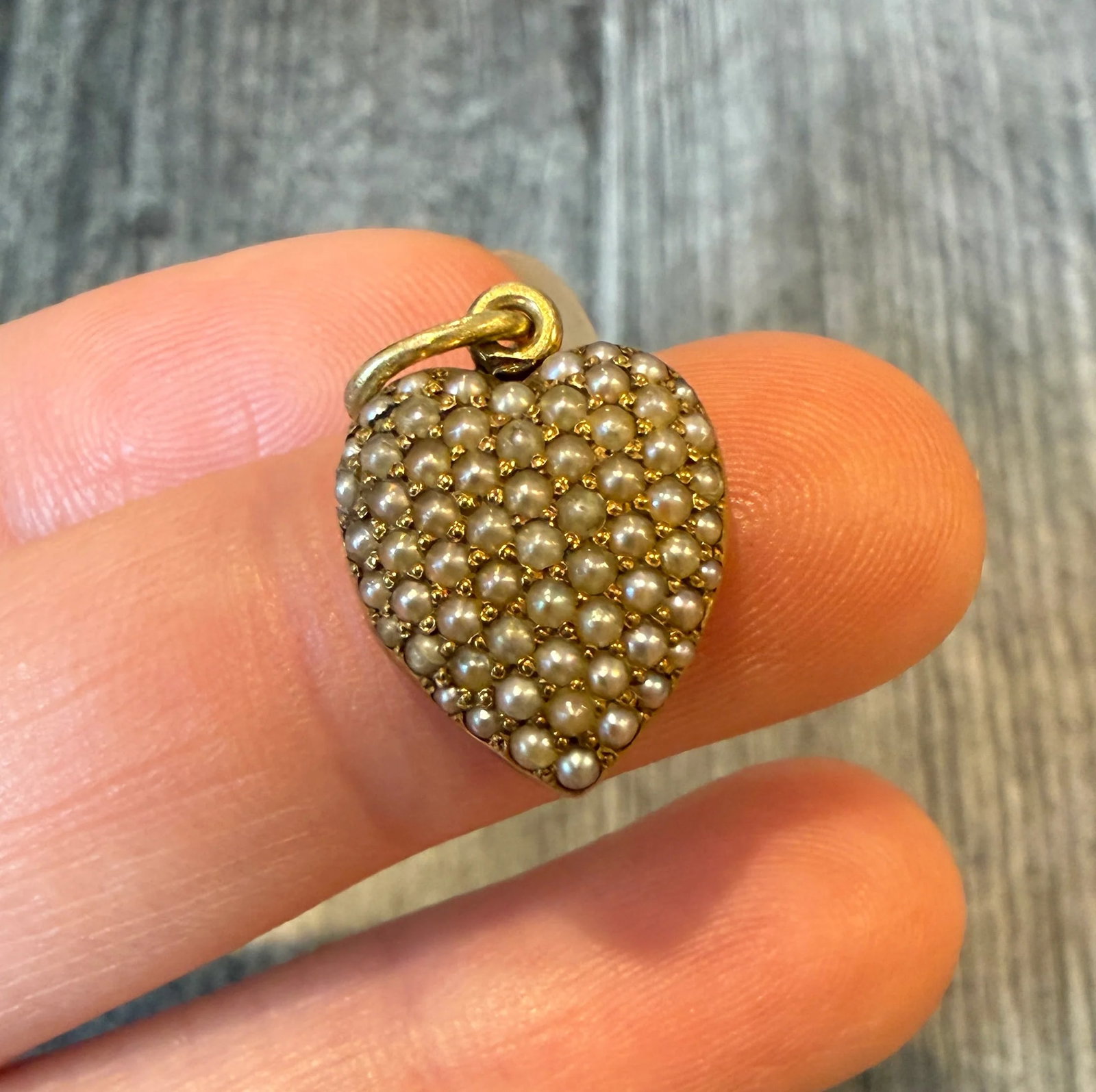 Small Edwardian Split Pearl Heart Locket in 14K Gold: Metal: 14K Yellow Gold Weight: 3.5 gramsMeasurements: 0.55 inches long by 0.55 inches wide Markings: "14K"Condition: In good antique condition with some surface wear consistent with age.