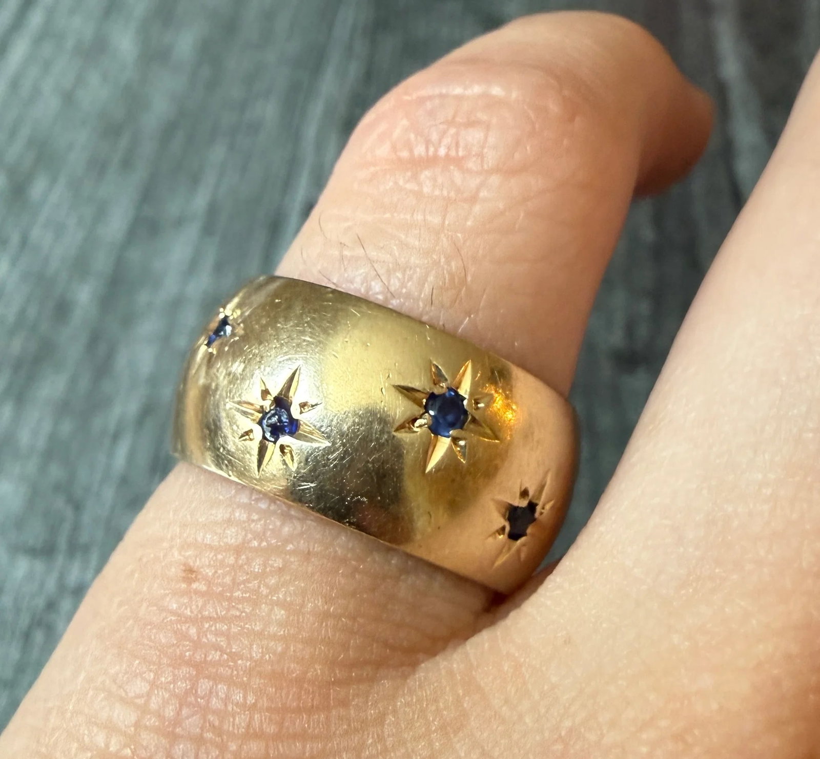 Midcentury Star Set Sapphire Band in 14K Gold, Size 6: Metal: 14K Yellow Gold Weight: 10.1 gramsSapphires: Approximately 0.30 caratsRing Size: 6.5 on the mandrel but fits more like a 6 due to width (not resizable)Width: 9.7 mm wideMarkings: "14"Condition: