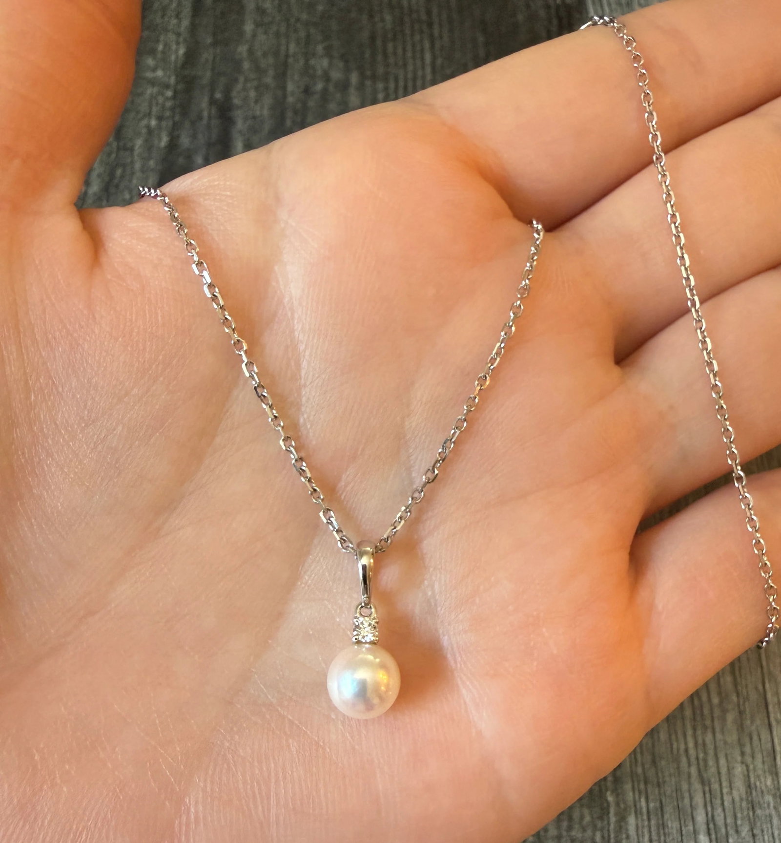 Mikimoto Akoya Pearl and Diamond Necklace: Metal: 18K White Gold Weight: 3.5 gramsPearl: 7 mm diameterDamond: Approximately 0.10 carats Chain Measurements: Adjustable from 15.5 inches long to 18 inches longWidth: 1.3 mm wide Markings: "750" wi