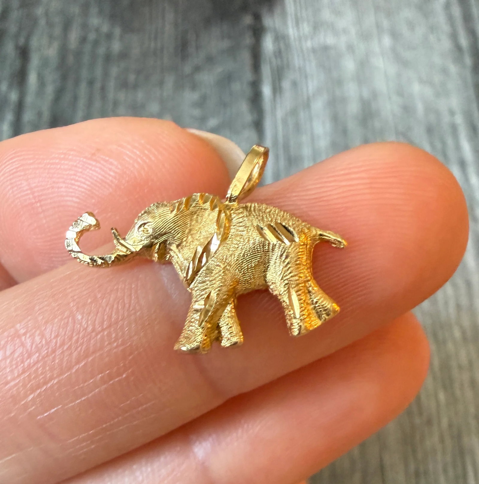 Elephant Charm in 14K Gold: Metal: 14K Yellow Gold Weight: 1.2 gramsMeasurements: 0.5 inches long by 0.85 wideMarkings: "14K"Condition: In very good condition with some minor surface wear