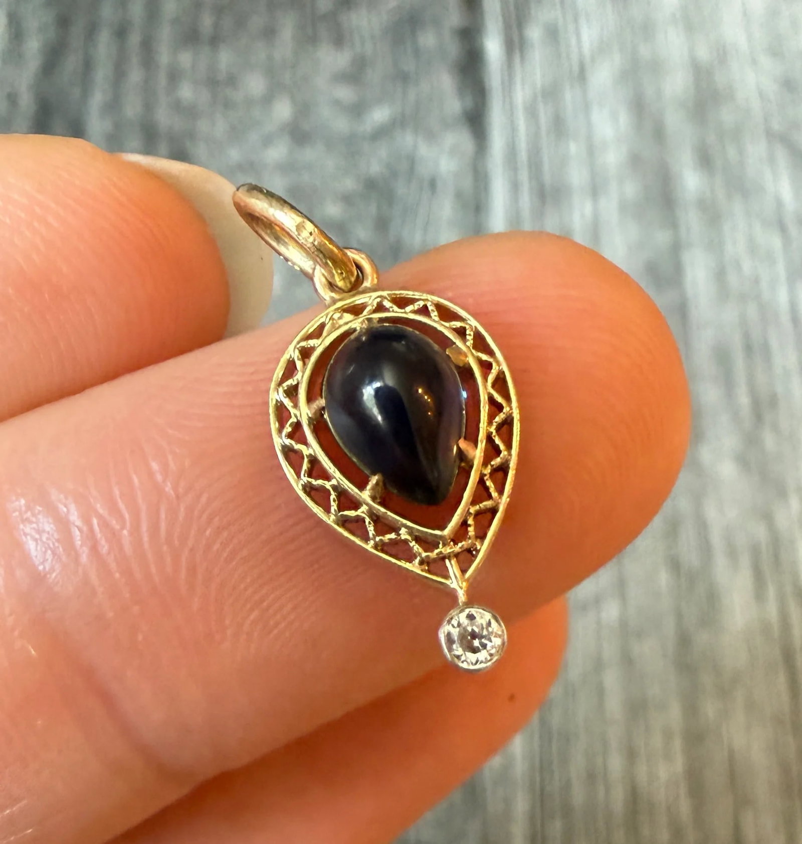 Art Deco Pear-Shaped Blue Stone Filigree Charm: Metal: 14K Yellow Gold (acid tested)Weight: 1.1 gramsMeasurements: 0.55 inches long by 0.3 inches wide Condition: In very good condition with some minor surface wear consistent with age. Most likely a